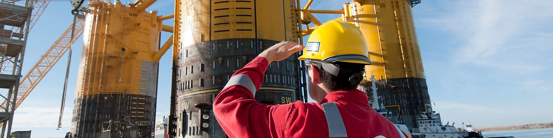 Engineer looking up at platform under construction