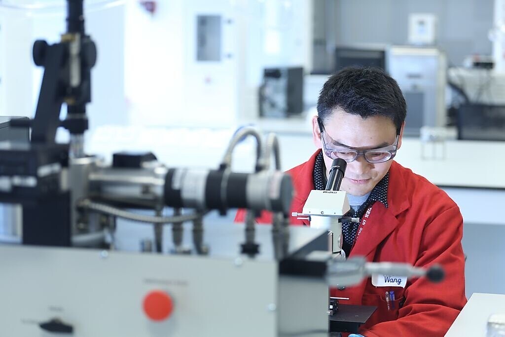 scientist viewing in a microscope