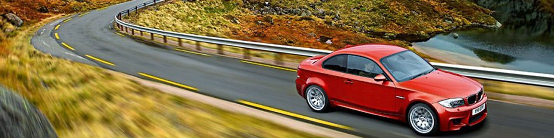 Red sedan driving on the road in Norway