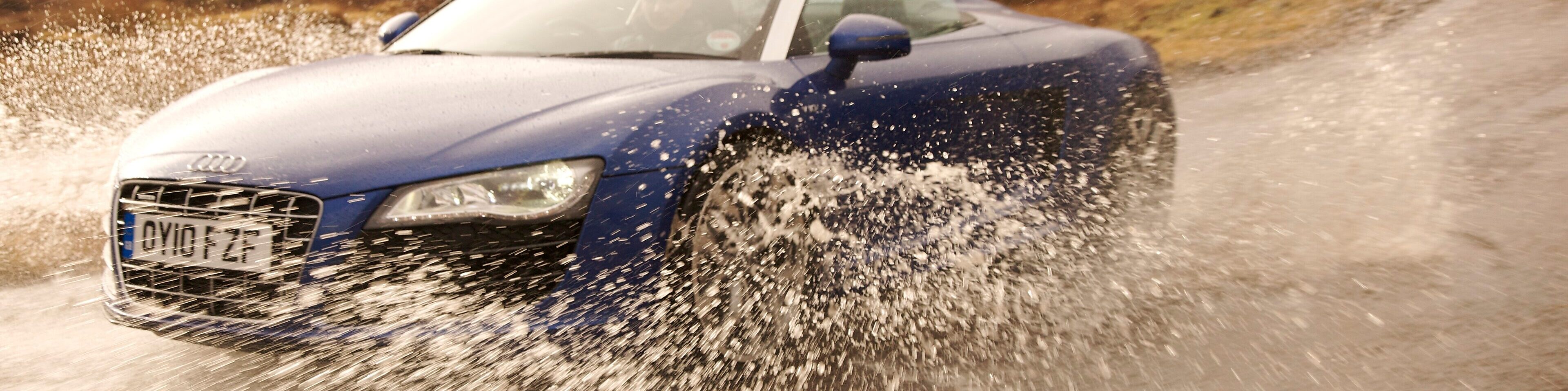 Car driving into the water on the country road