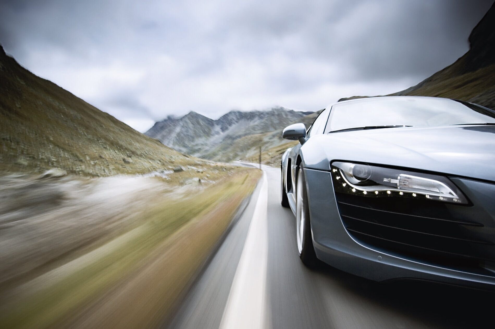 car driving along a winding mountain road