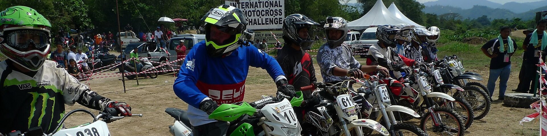 Motorcross motorcycles lining up at the start of a race