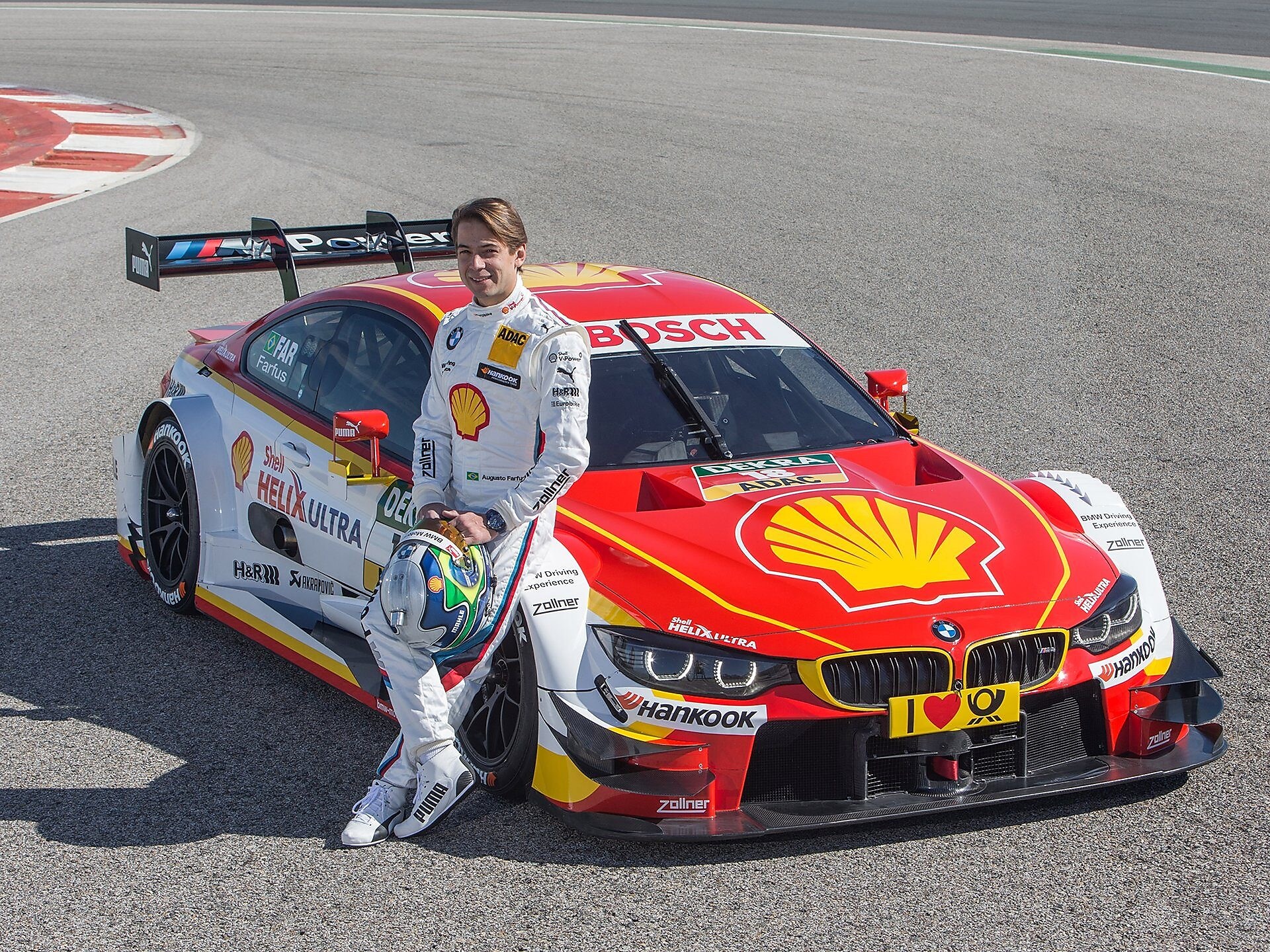 BMW motorsport driver leaning on a car which uses a bespoke Shell Helix oil formulation 