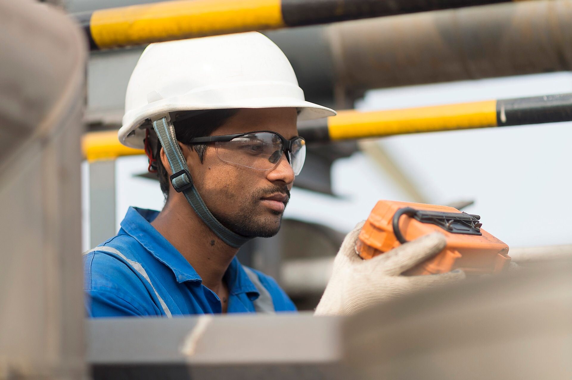 LNG Technology employee conducts routine inspection at the top of an LNG tank