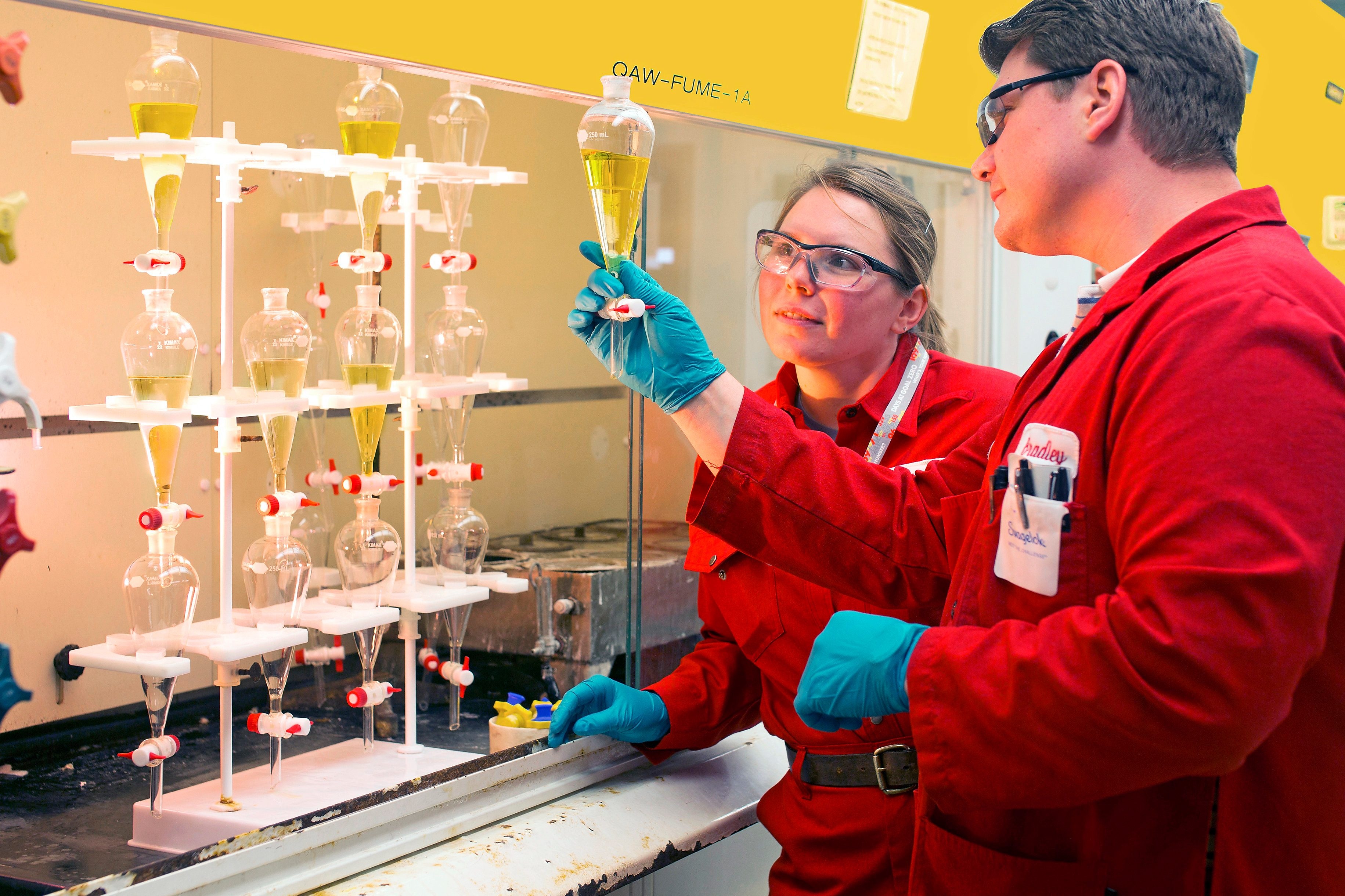 Shell employees look at ethylene oxide production samples